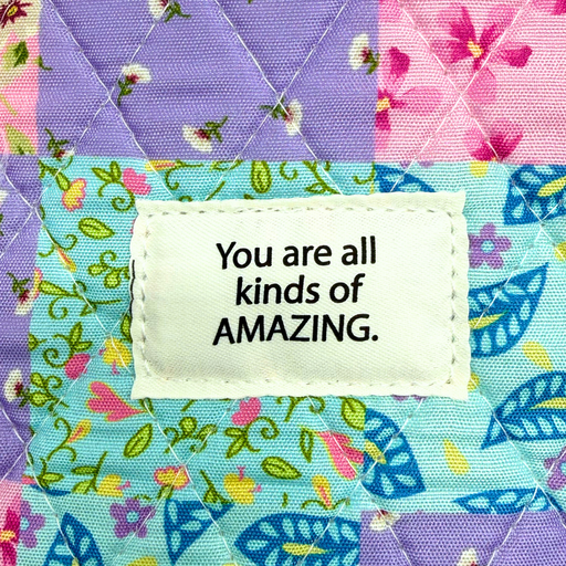 Colorful fabric patch with a motivational message on a multicolored background