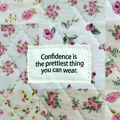 Floral fabric with a motivational quote tag on a floral background