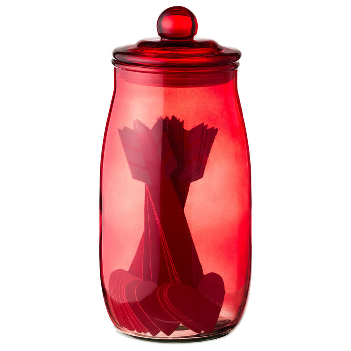 Red glass jar with a lid on a white background