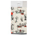 A packaged Hallmark tea towel featuring a Halloween-themed pattern with black trees, orange pumpkins, a ghost, a witch riding a red sleigh, and small red stars on an off-white background.