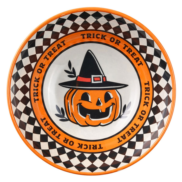 A round Halloween-themed ceramic bowl featuring a black and white checkered border, an orange rim with the words 'TRICK OR TREAT' repeated, and a central jack-o'-lantern wearing a black witch hat.