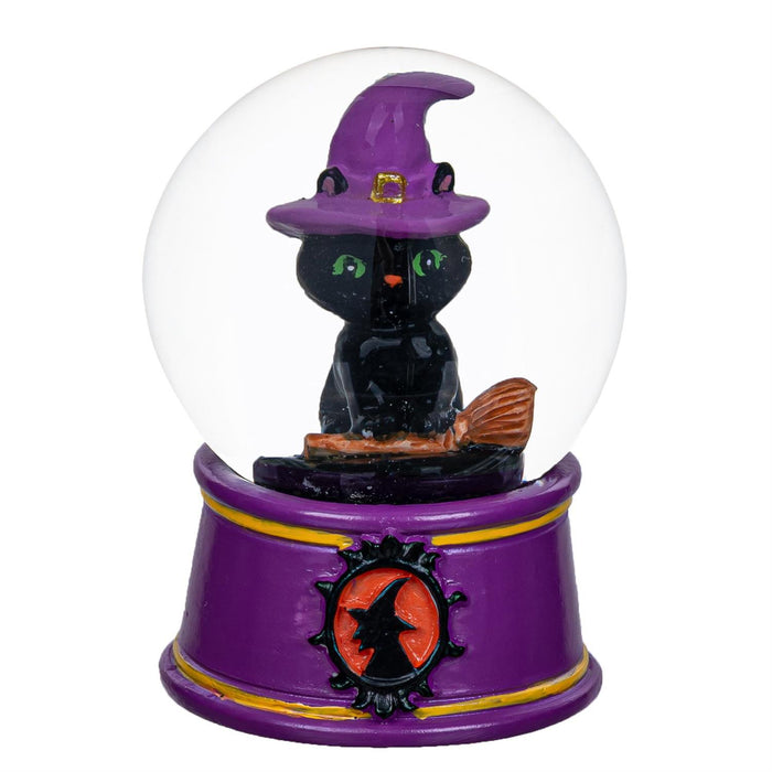Black cat in a witch hat inside a snow globe with a purple base on a white background