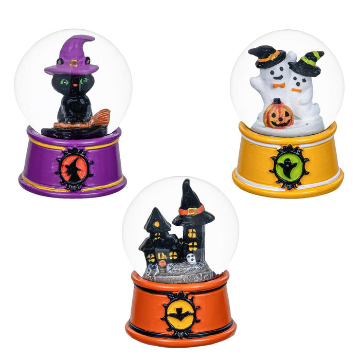 Three Halloween-themed snow globes on a white background