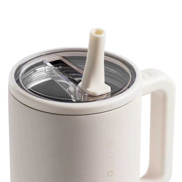 White mug with straw lid on a white background