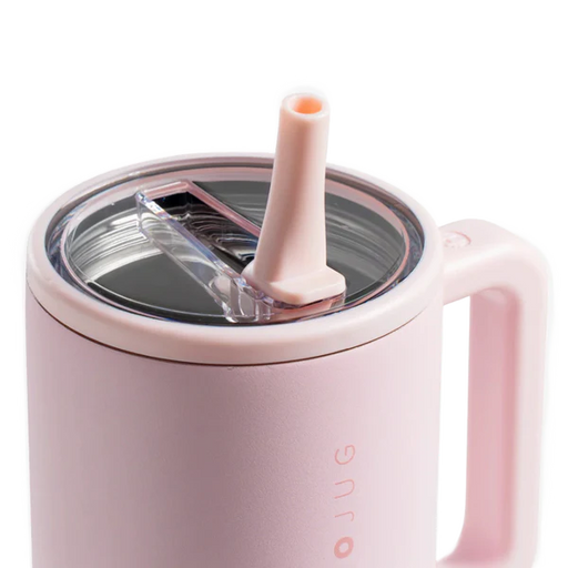 Pink mug with a straw lid on a white background
