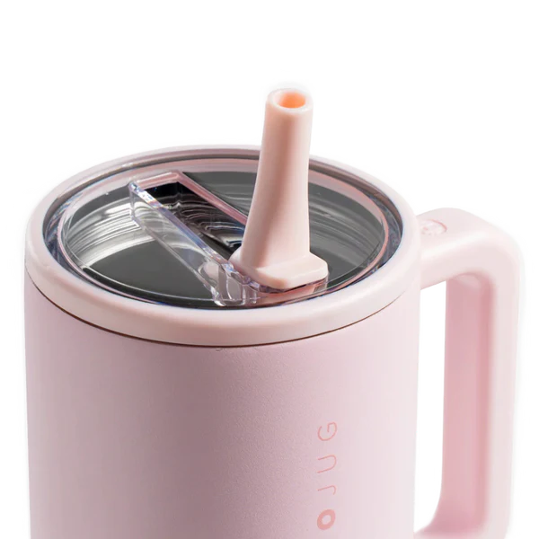 Pink mug with a straw lid on a white background
