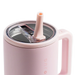 Pink mug with a straw lid on a white background