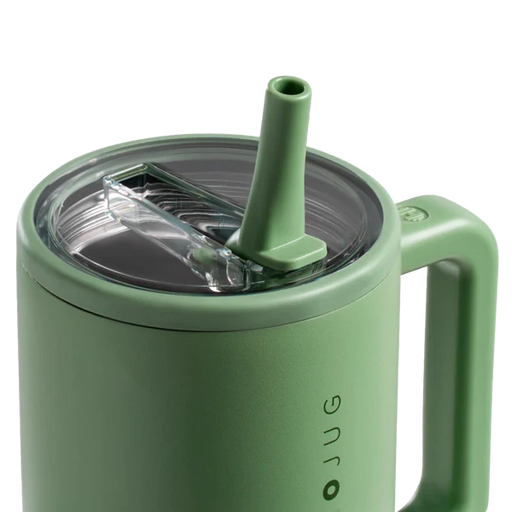 Green mug with straw lid on a white background