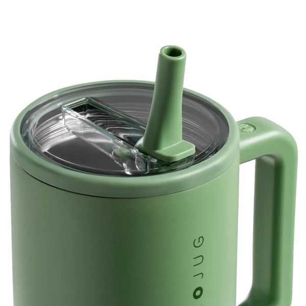 Green mug with straw lid on a white background