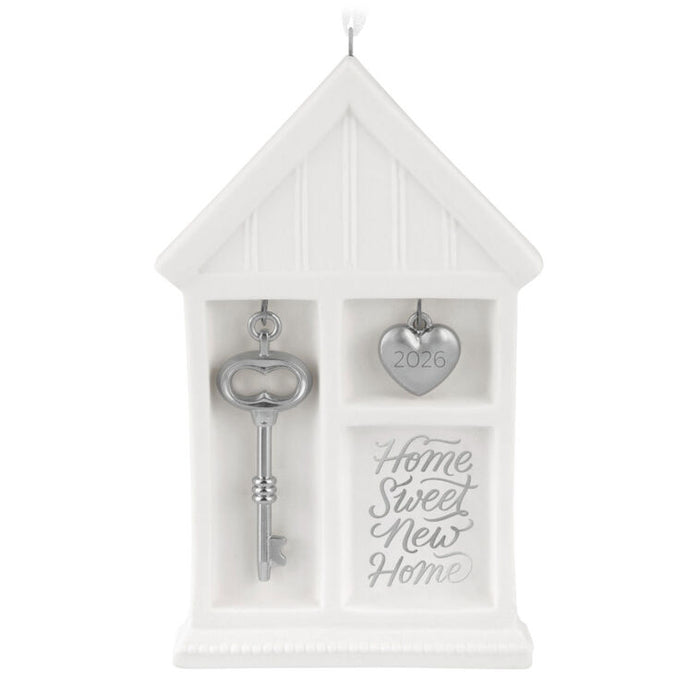 Decorative white box with a key and heart-shaped object, featuring 'Home Sweet New Home' text.
