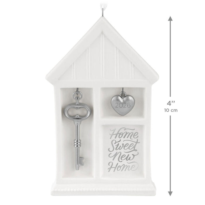 Decorative gift set with key and heart-shaped token in a white box, featuring 'Home Sweet New Home' text.