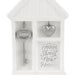 Decorative key and heart charm set in a white house-shaped box with 'Home Sweet New Home' text.