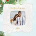 Decorative ornament with a couple's photo and 'Best love story ever' text, surrounded by Christmas tree branches.