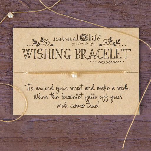 Wishing bracelet with instructions on a wooden background