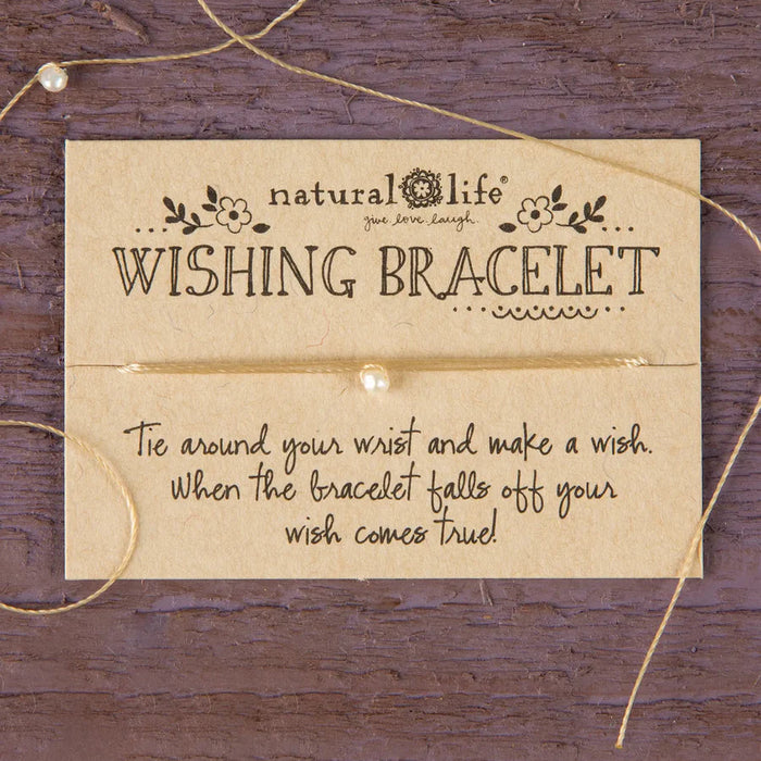 Wishing bracelet with instructions on a wooden background