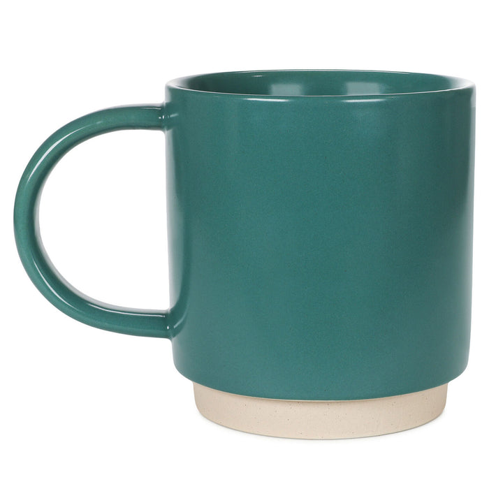 Teal mug with a beige base on a white background