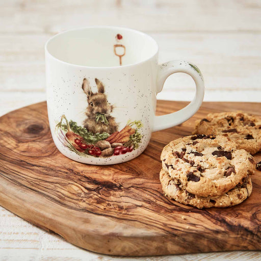 White mug with a rabbit design on a wooden board with cookies