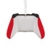 A novelty Christmas ornament shaped like a white video game controller with red side grips and black top accents, hanging by a clear ribbon on a white background.