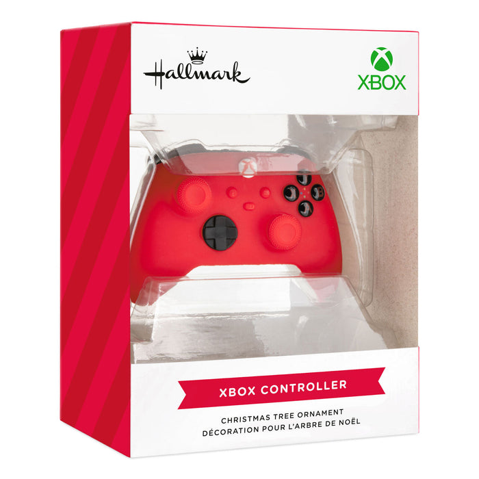A red Xbox controller Christmas tree ornament displayed inside its retail packaging, featuring the Hallmark and Xbox logos on a white and red box.