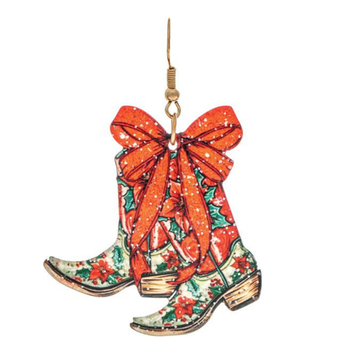 Christmas earrings shaped like a pair of cowboy boots with a red glittery bow, featuring a holiday print of red poinsettias and green holly on an off-white background, complete with a gold hanging hook.