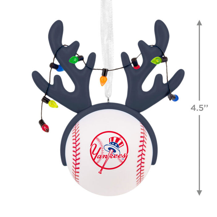 A Yankee baseball Christmas ornament with dark gray reindeer antlers, hanging white ribbon, and multicolor string lights, shown on a white background with a 4.5-inch height measurement marker.