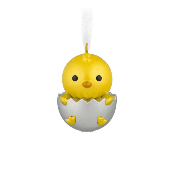 Yellow chick in an eggshell ornament on a white background