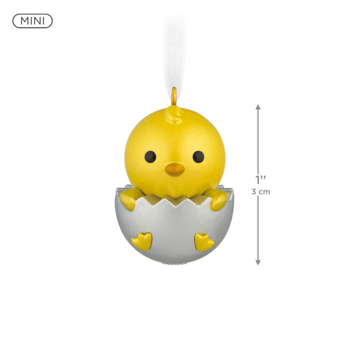 Yellow chick toy in an egg壳 with a measurement label on a white background