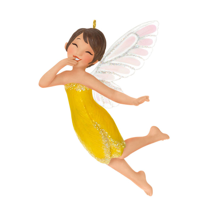 Fairy figurine with white wings and a yellow dress on a white background