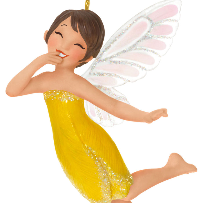 Fairy figurine with a yellow dress and white wings on a white background