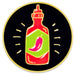 A circular enamel pin featuring a stylized red chili sauce bottle with a green label and pink chili pepper, set against a black background with small white light rays and a gold border.