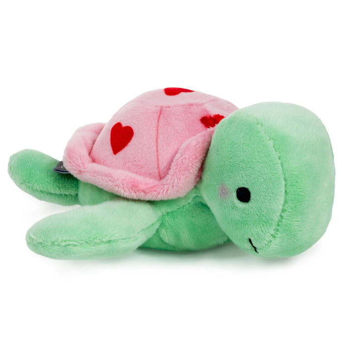 Green plush turtle with a pink shell featuring red hearts on a white background