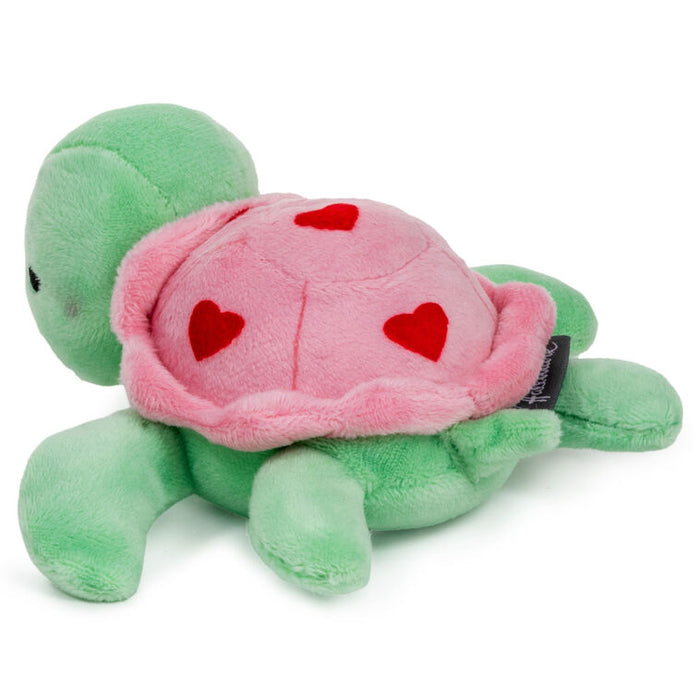 Plush turtle toy with pink shell and red hearts on a white background