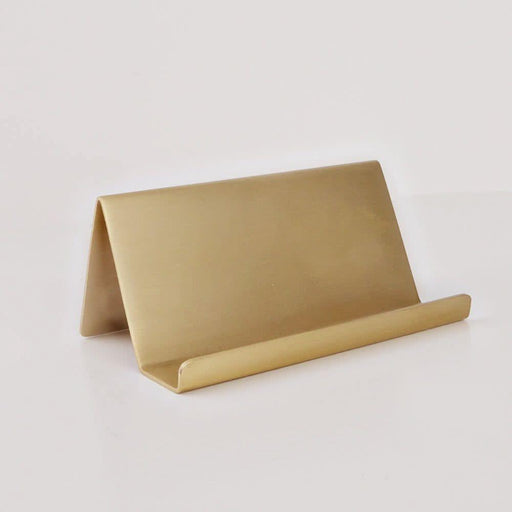 A minimalist gold metal tabletop organizer with a triangular stand and a curved horizontal bar, shown on a clean white background.