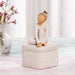 2.25” tall carved figure of dancer in cream leotard affixed to lid of 3” tall box
