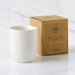 White candle with 'William Tree' branding next to its packaging on a white background