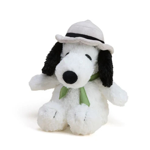 Plush toy of a dog wearing a hat and scarf on a white background