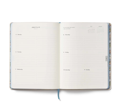 Open planner with daily schedule and calendar on a white background