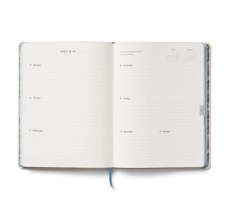 Open planner with daily schedule and calendar on a white background