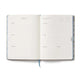 Open planner with daily schedule and calendar on a white background