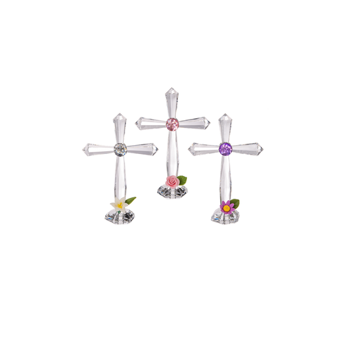 Three decorative crosses with colorful gemstones and flowers on a white background