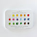 A metal tin watercolor paint set by Emily Lee Studio, showing 18 color wells with labeled watercolor swatches on a white background.