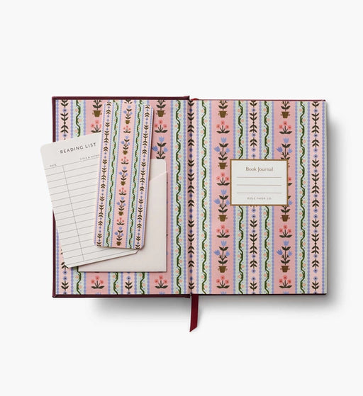 Patterned notebook with a bookmark and reading list on a white background