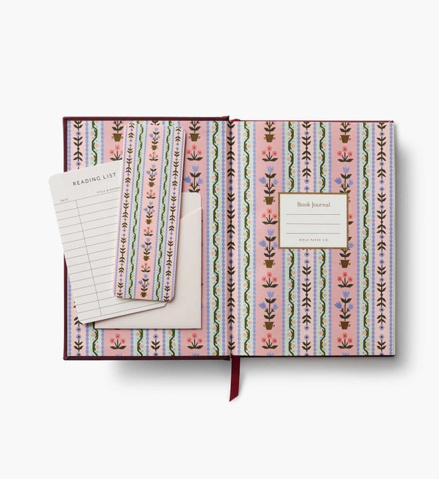 Patterned notebook with a bookmark and reading list on a white background