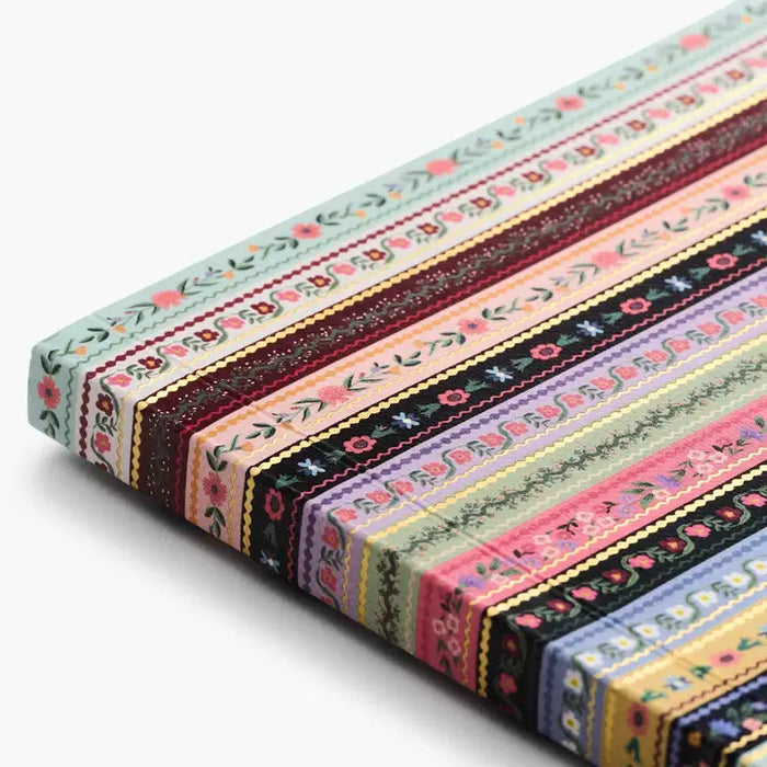 Set of colorful fabric strips with floral patterns on a white background
