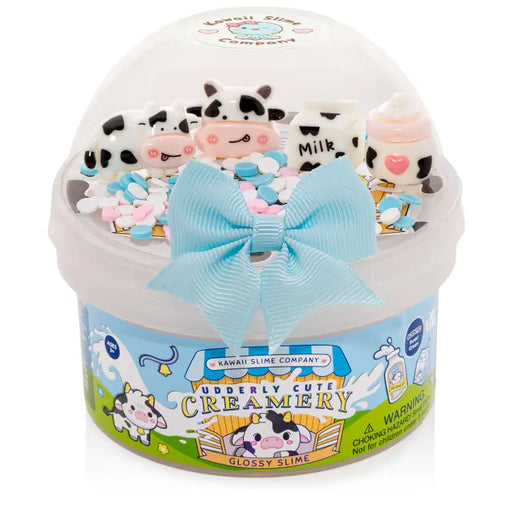Kawaii slime product with cow-themed figures and a blue bow on a white background