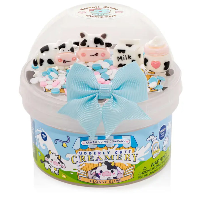 Kawaii slime product with cow-themed figures and a blue bow on a white background