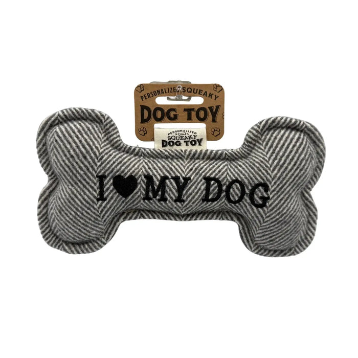 Bone shaped dog toy that says 'I LOVE MY DOG' on a white background