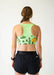 Person wearing a green sports bra with cactus design and black shorts on a white background