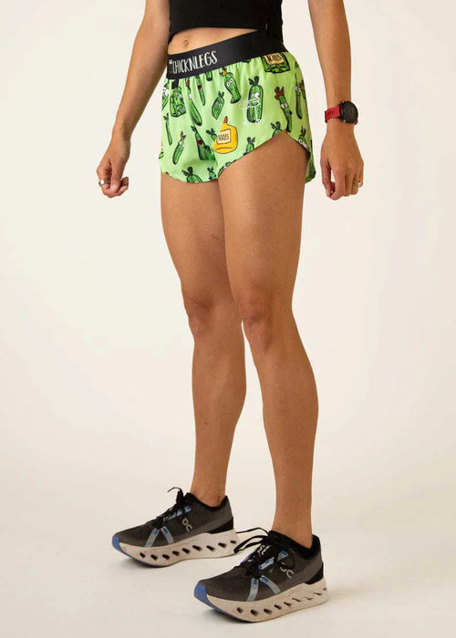 Person wearing green patterned shorts on a plain background