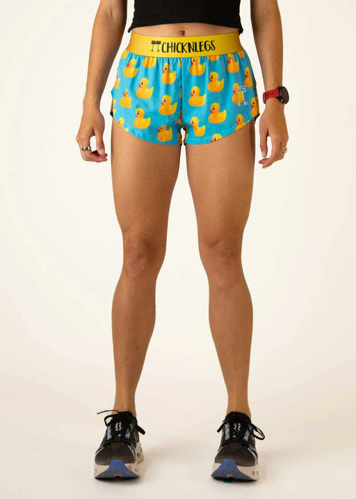 Person wearing blue shorts with yellow rubber duck pattern and yellow waistband on a white background